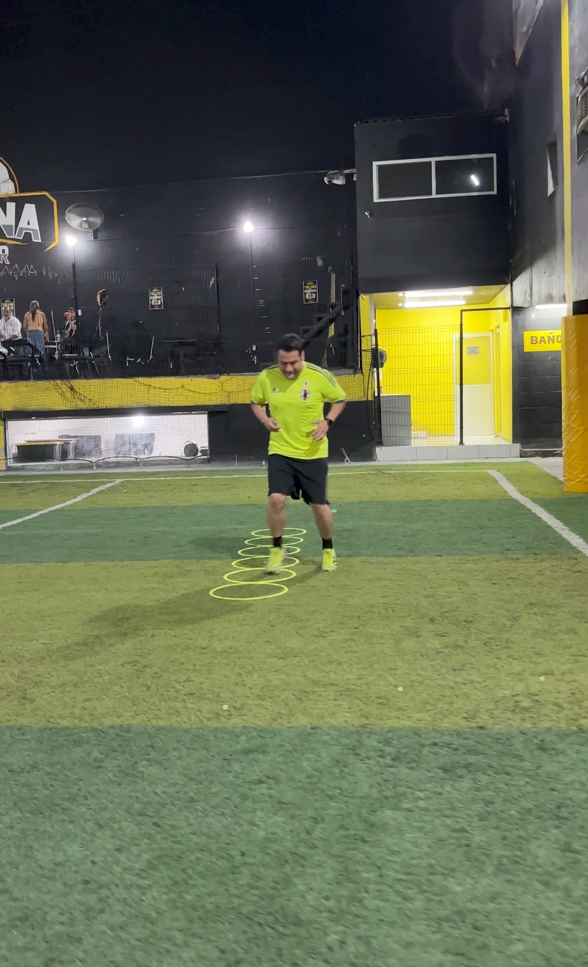 Adulto entrenando con aros en la cancha
